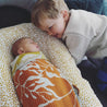 Little boy staring lovingly at cute baby in Offspring Baby Blanket