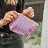 Woman holding pink bollywood beauty clutch