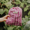 Hand holding pink offspring bag